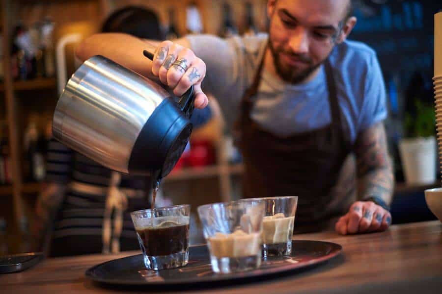 barista pouring coffee oat milk