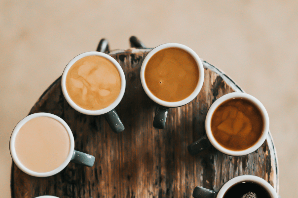 coffee cups with different amounts of milk in them