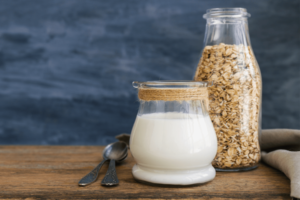 oat milk in jug oats in jug