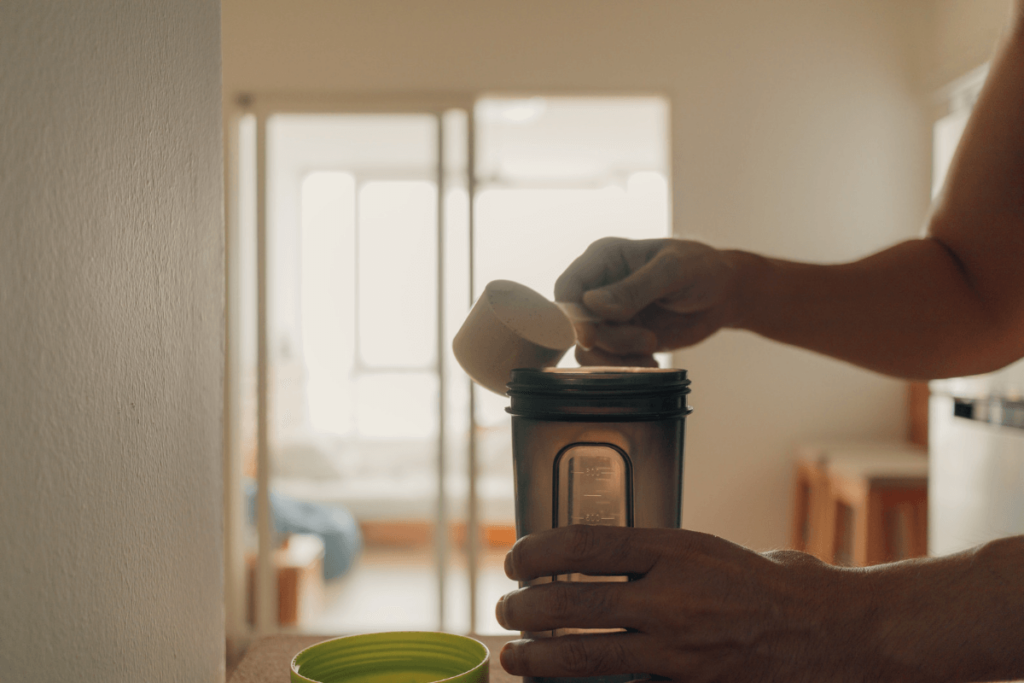 protein powder being added to a shaker